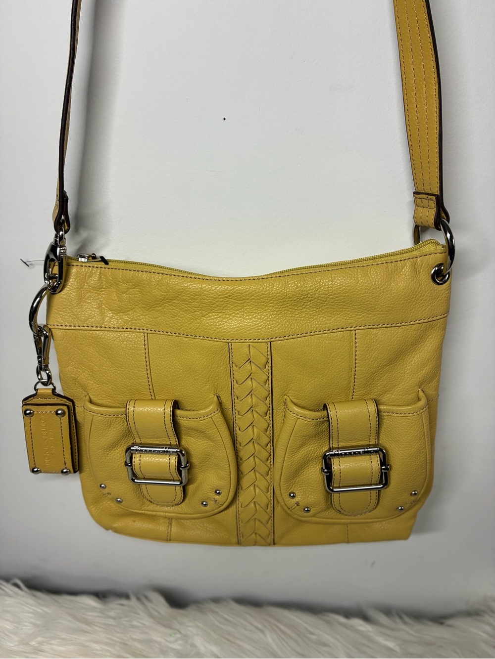 Mustard colored women’s bag with silver hardware